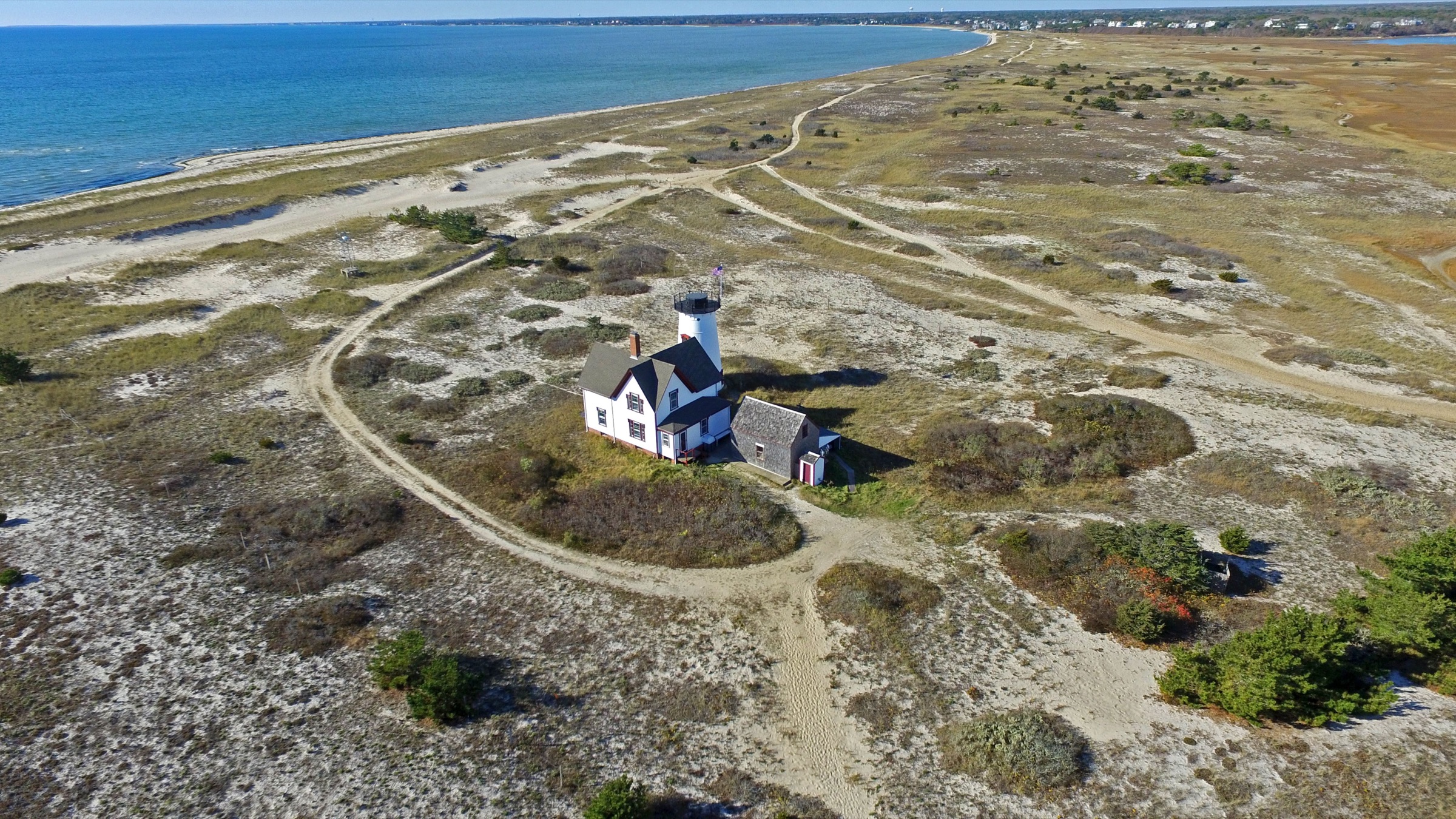 Aerial view of a Cape Cod lighthouse and coastline
